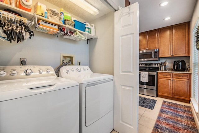 1515 Bayshore Blvd Unit 38, Dunedin, FL 34698 - laundry room with washing machine and clothes dryer, light tile patterned flooring, and recessed lighting