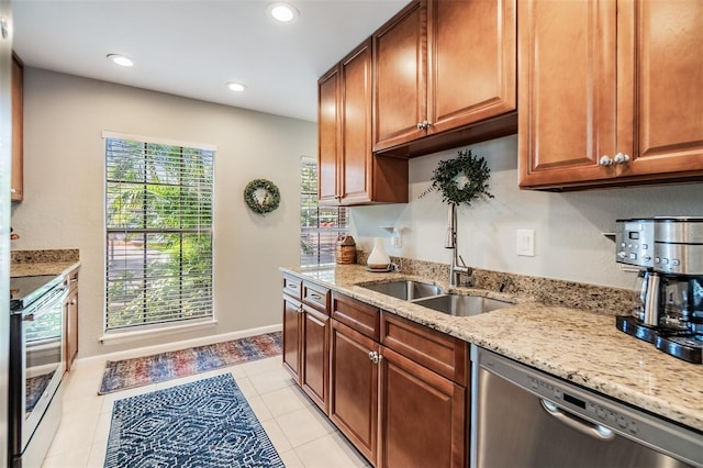 1515 Bayshore Blvd Unit 38, Dunedin, FL 34698 - kitchen with stainless steel appliances, light stone counters, recessed lighting, light tile patterned flooring, and brown cabinets