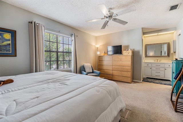 1515 Bayshore Blvd Unit 38, Dunedin, FL 34698 - bedroom featuring a textured ceiling, carpet, ensuite bathroom, and a ceiling fan