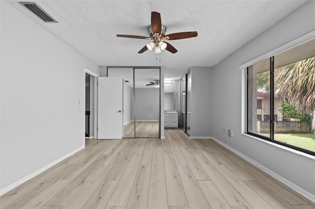 4160 Player Cir Unit 109, Orlando, FL 32808 - unfurnished bedroom with light wood-style floors, a textured ceiling, baseboards, and ceiling fan