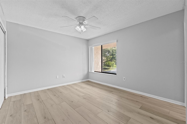 4160 Player Cir Unit 109, Orlando, FL 32808 - spare room featuring a textured ceiling, ceiling fan, wood finished floors, and baseboards