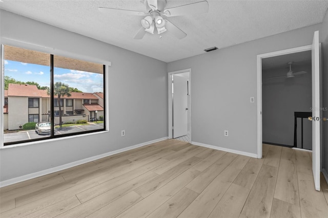 4160 Player Cir Unit 109, Orlando, FL 32808 - unfurnished bedroom with a spacious closet, wood finished floors, a textured ceiling, a closet, and baseboards
