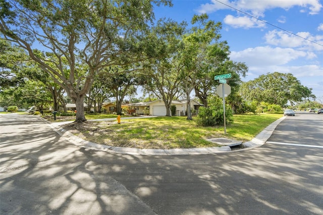 5825 Oakhurst Dr, Seminole, FL 33772 - view of front facade featuring an attached garage and a front lawn