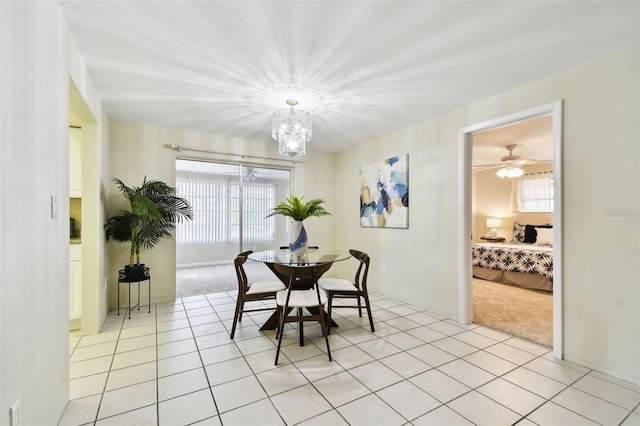 5825 Oakhurst Dr, Seminole, FL 33772 - dining space featuring a chandelier, light tile patterned floors, and light colored carpet