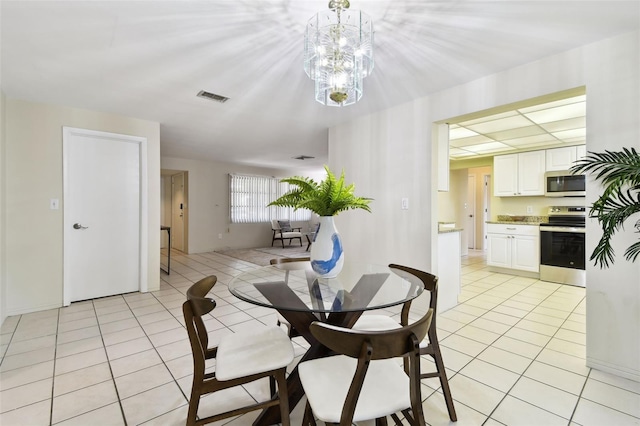 5825 Oakhurst Dr, Seminole, FL 33772 - dining area featuring light tile patterned floors and a chandelier