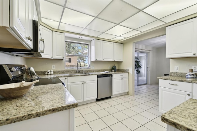 5825 Oakhurst Dr, Seminole, FL 33772 - kitchen featuring stainless steel appliances, a sink, white cabinets, light tile patterned floors, and light stone countertops