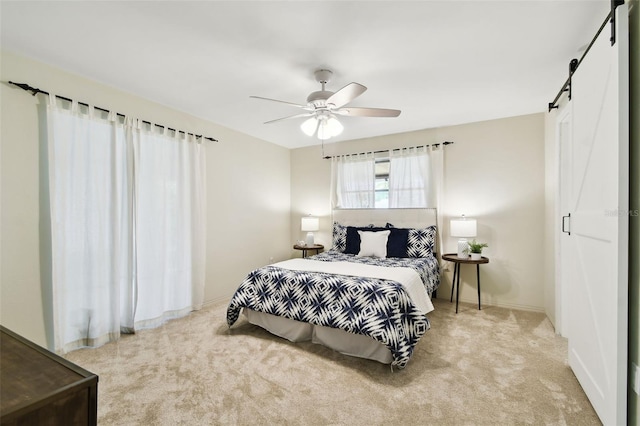 5825 Oakhurst Dr, Seminole, FL 33772 - bedroom featuring a barn door, carpet flooring, and ceiling fan
