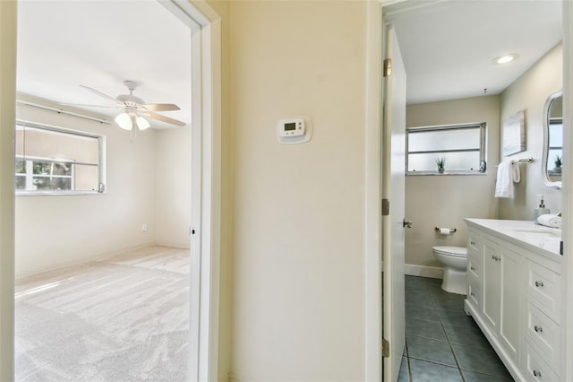 5825 Oakhurst Dr, Seminole, FL 33772 - bathroom featuring vanity, ceiling fan, toilet, and healthy amount of natural light