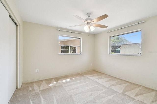 5825 Oakhurst Dr, Seminole, FL 33772 - unfurnished bedroom with carpet flooring, a closet, a ceiling fan, and baseboards