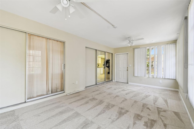 5825 Oakhurst Dr, Seminole, FL 33772 - spare room featuring ceiling fan, carpet, and baseboards