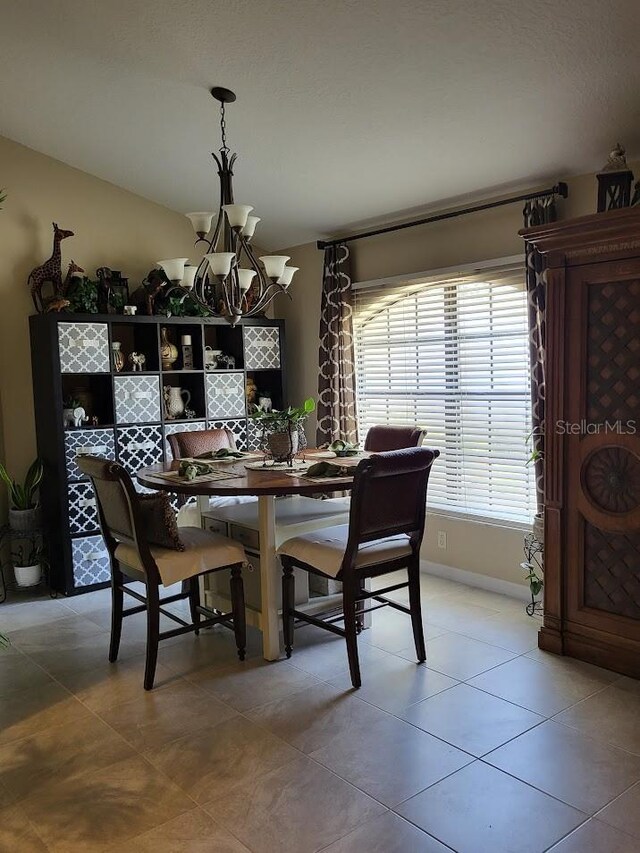 4471 Marsh Harbor Dr, Tavares, FL 32778 - dining area featuring a chandelier, light tile patterned floors, and baseboards