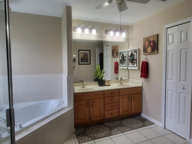 4471 Marsh Harbor Dr, Tavares, FL 32778 - full bath featuring a garden tub, double vanity, tile patterned floors, a ceiling fan, and a closet