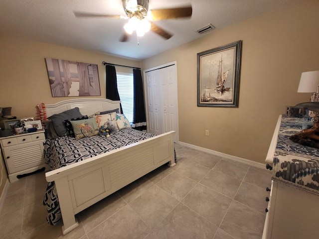 4471 Marsh Harbor Dr, Tavares, FL 32778 - bedroom with light tile patterned flooring, baseboards, a closet, and a ceiling fan