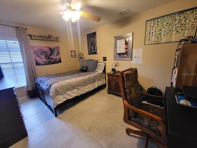 4471 Marsh Harbor Dr, Tavares, FL 32778 - bedroom with light tile patterned floors, an office area, and ceiling fan