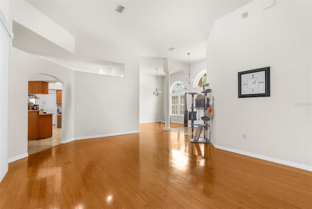 8518 N Linwood Loop, Citrus Springs, FL 34433 - living room featuring arched walkways, light wood finished floors, and baseboards