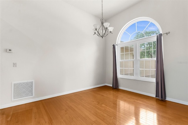 8518 N Linwood Loop, Citrus Springs, FL 34433 - empty room with a chandelier, light wood-style floors, and baseboards