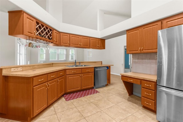 8518 N Linwood Loop, Citrus Springs, FL 34433 - kitchen featuring stainless steel appliances, a sink, light countertops, decorative backsplash, and brown cabinetry