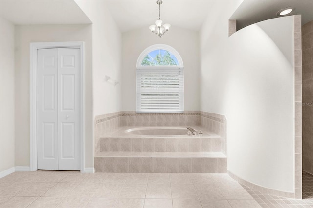 8518 N Linwood Loop, Citrus Springs, FL 34433 - bathroom with a bath, tile patterned floors, a closet, vaulted ceiling, and a chandelier