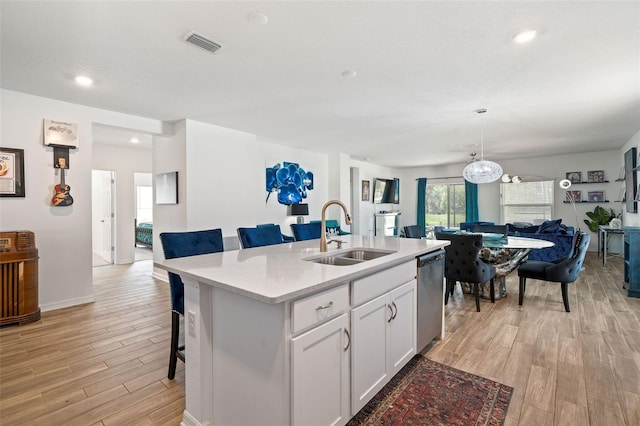 5511 Badini Way, Palmetto, FL 34221 - kitchen with a sink, open floor plan, dishwasher, light wood-style floors, and recessed lighting