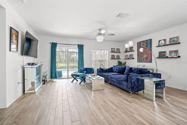 5511 Badini Way, Palmetto, FL 34221 - living area featuring light wood finished floors, ceiling fan, and baseboards