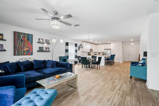 5511 Badini Way, Palmetto, FL 34221 - living room featuring light wood finished floors, a ceiling fan, recessed lighting, and baseboards