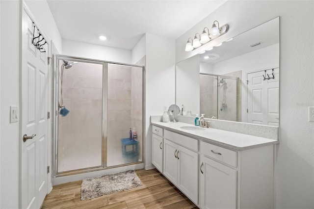 5511 Badini Way, Palmetto, FL 34221 - full bathroom featuring a shower stall, wood finished floors, vanity, and recessed lighting