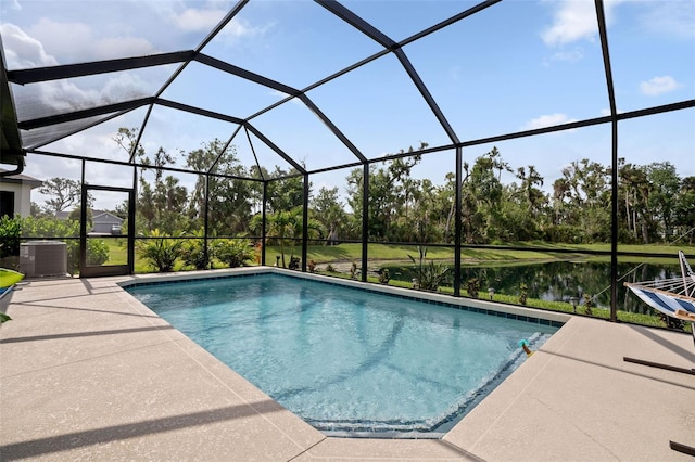 5511 Badini Way, Palmetto, FL 34221 - swimming pool featuring central air condition unit, a patio area, glass enclosure, and view of wooded area