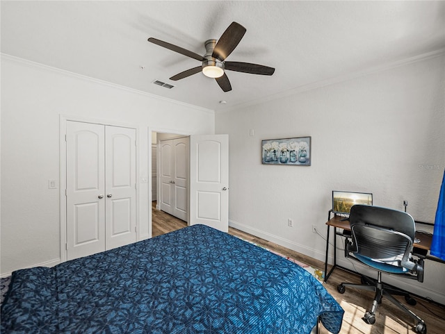 4221 W Spruce St Unit 2302, Tampa, FL 33607 - bedroom with wood finished floors, ornamental molding, a desk, a closet, and baseboards