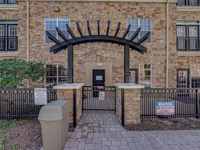4221 W Spruce St Unit 2302, Tampa, FL 33607 - entrance to property featuring a gate and stone siding
