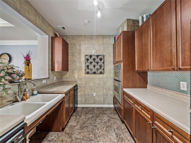 4221 W Spruce St Unit 2302, Tampa, FL 33607 - kitchen with a sink, double oven, light countertops, and backsplash