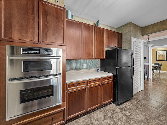 4221 W Spruce St Unit 2302, Tampa, FL 33607 - kitchen featuring double oven, freestanding refrigerator, and light countertops