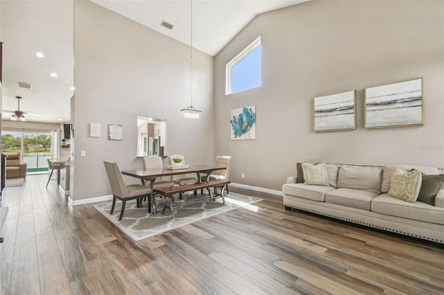 12102 Steppingstone Blvd, Tampa, FL 33635 - living room with baseboards, wood finished floors, high vaulted ceiling, ceiling fan, and recessed lighting