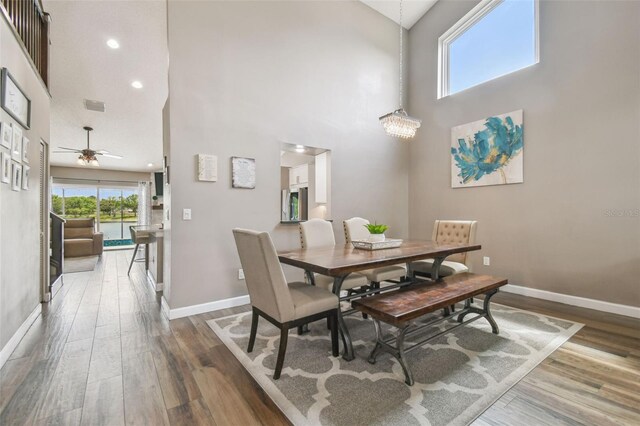 12102 Steppingstone Blvd, Tampa, FL 33635 - dining space with a towering ceiling, baseboards, ceiling fan, wood finished floors, and recessed lighting