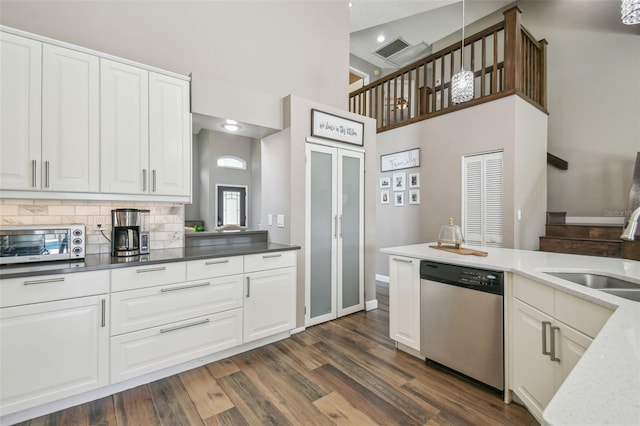 12102 Steppingstone Blvd, Tampa, FL 33635 - kitchen featuring dishwasher, a sink, a high ceiling, white cabinetry, and dark wood-style flooring