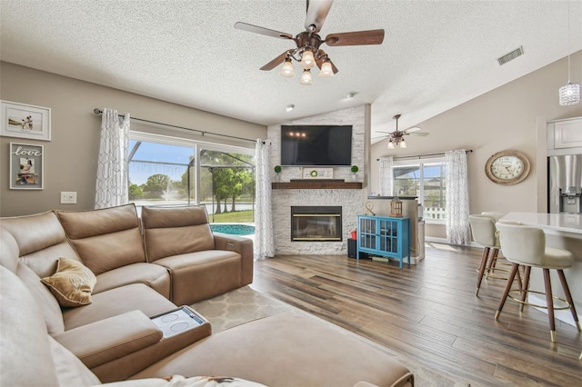 12102 Steppingstone Blvd, Tampa, FL 33635 - living room featuring a textured ceiling, a ceiling fan, plenty of natural light, vaulted ceiling, and wood finished floors