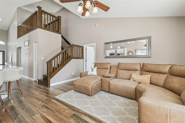 12102 Steppingstone Blvd, Tampa, FL 33635 - living room featuring high vaulted ceiling, a ceiling fan, wood finished floors, stairs, and baseboards