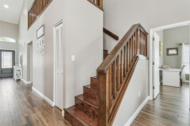 12102 Steppingstone Blvd, Tampa, FL 33635 - staircase with wood finished floors, a high ceiling, and baseboards