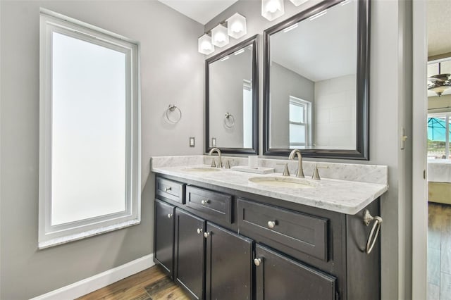 12102 Steppingstone Blvd, Tampa, FL 33635 - full bathroom with wood finished floors, double vanity, and baseboards