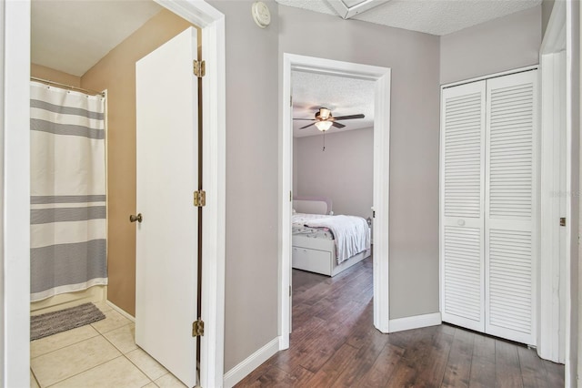 12102 Steppingstone Blvd, Tampa, FL 33635 - hallway featuring a textured ceiling, baseboards, and wood finished floors