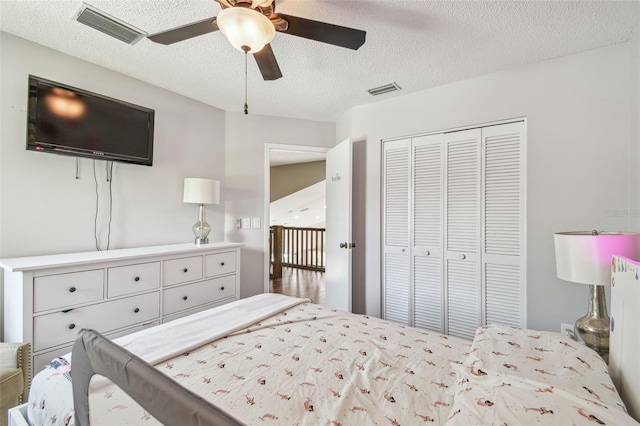 12102 Steppingstone Blvd, Tampa, FL 33635 - bedroom with a textured ceiling, a closet, and a ceiling fan