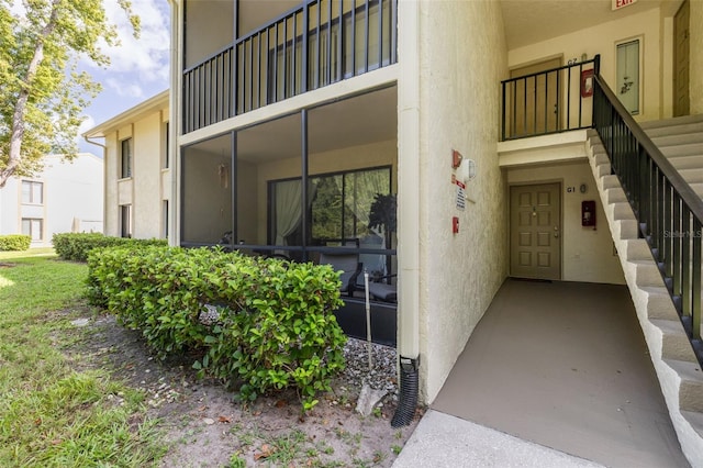 3114 Lake Pine Way Unit G1, Tarpon Springs, FL 34688 - doorway to property with stucco siding