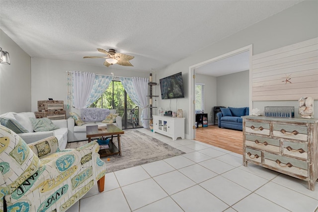 3114 Lake Pine Way Unit G1, Tarpon Springs, FL 34688 - living area featuring ceiling fan, light tile patterned flooring, and a textured ceiling
