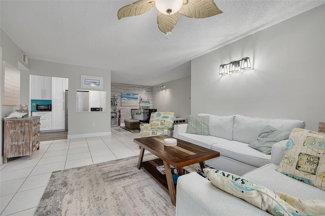 3114 Lake Pine Way Unit G1, Tarpon Springs, FL 34688 - living room featuring light tile patterned floors, ceiling fan, a textured ceiling, a fireplace, and baseboards