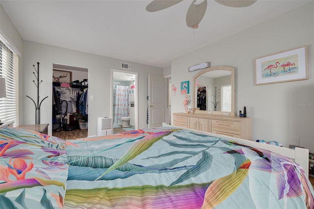 3114 Lake Pine Way Unit G1, Tarpon Springs, FL 34688 - bedroom featuring a walk in closet, a closet, ensuite bath, and a ceiling fan