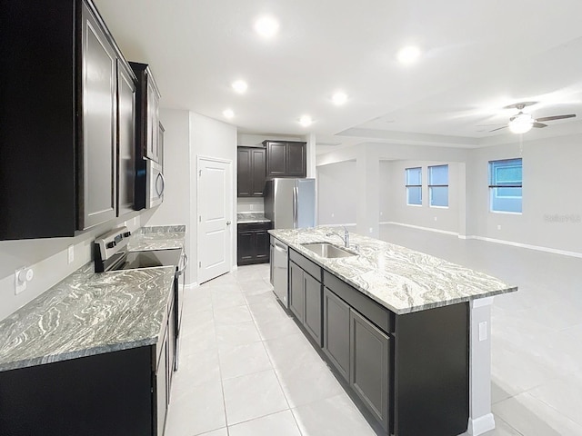 13014 Willow Grove Dr, Riverview, FL 33579 - kitchen with a sink, appliances with stainless steel finishes, light tile patterned floors, an island with sink, and light stone countertops