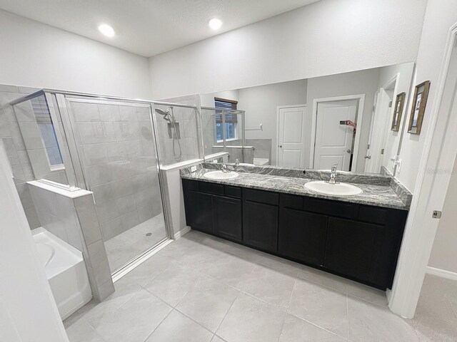 13014 Willow Grove Dr, Riverview, FL 33579 - bathroom featuring a stall shower, double vanity, a bath, tile patterned flooring, and recessed lighting