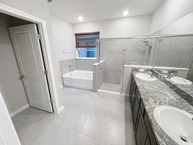 13014 Willow Grove Dr, Riverview, FL 33579 - bathroom with double vanity, a shower stall, a bath, tile patterned floors, and baseboards