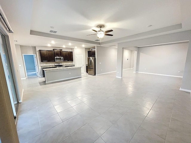 13014 Willow Grove Dr, Riverview, FL 33579 - unfurnished living room featuring a tray ceiling, a ceiling fan, light tile patterned floors, baseboards, and recessed lighting
