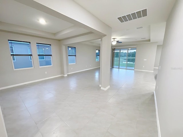 13014 Willow Grove Dr, Riverview, FL 33579 - empty room featuring ceiling fan, a raised ceiling, baseboards, and light tile patterned floors