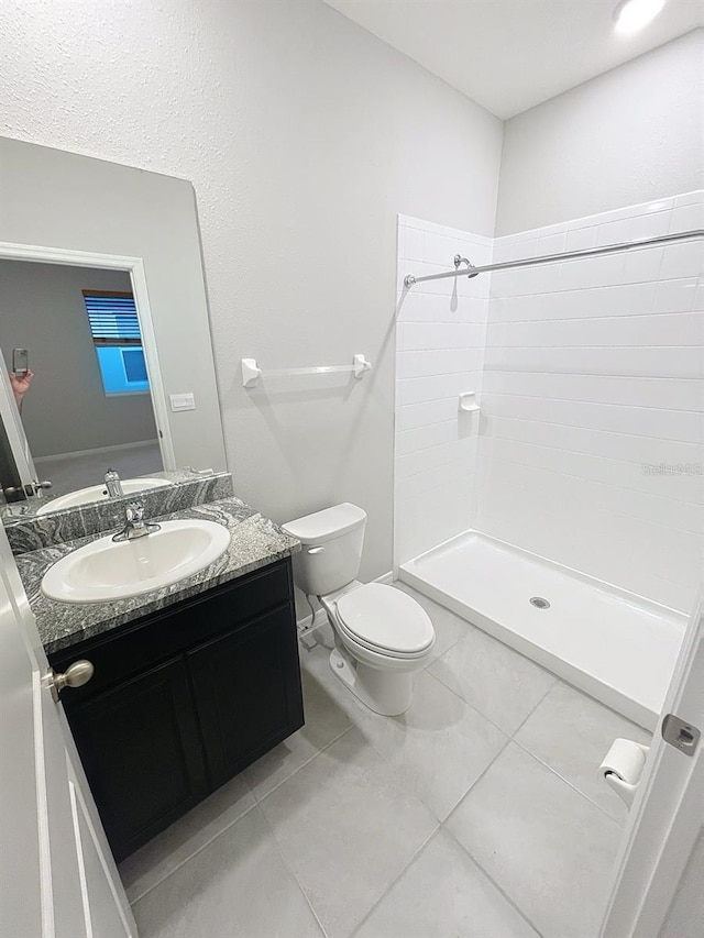 13014 Willow Grove Dr, Riverview, FL 33579 - bathroom with vanity, toilet, a tile shower, and tile patterned floors